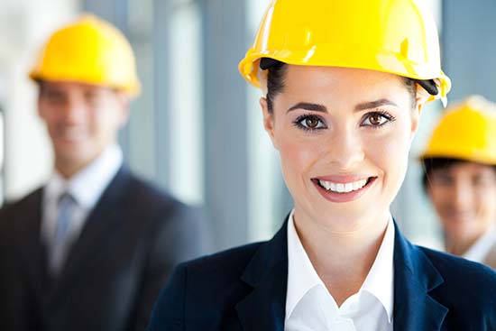 women and men wearing suits and construction hard hats