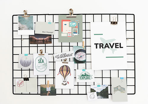 pin board with travel souvenirs on it