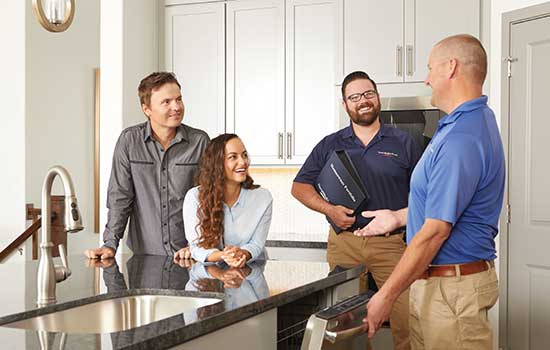 David Weekley Homeowners sitting at a counter with a Warranty Represenative and Builder