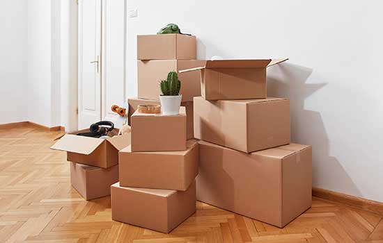 stack of cardboard moving boxes near an interior door