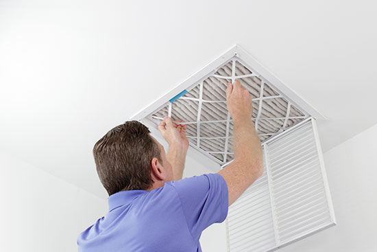 man installing air conditioner air filter