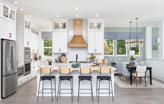 This kitchen and dining area in The Fruition Model Home is spotless and features both natural light and updated light fixtures.