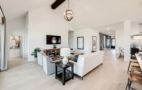 A view of the open floor plan, overlooking the family room, dining space and entry from the back door of a David Weekley model home.