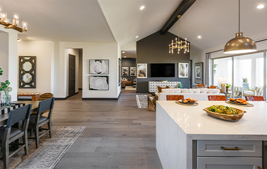 A view of the open floor plan, overlooking the family room, dining space and TV room from the kitchen island of a David Weekley model home.