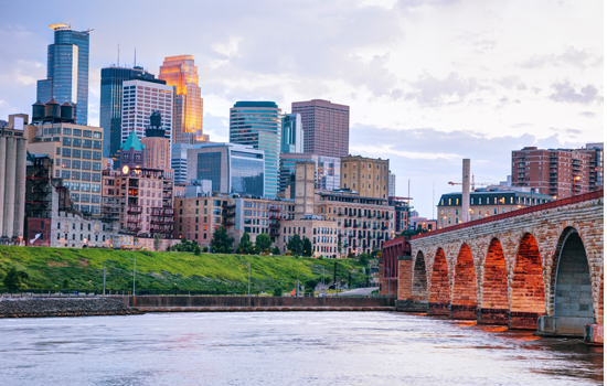 Downtown Minneapolis seen from across the Mississippi River, where many people who move to Minneapolis will commute to work