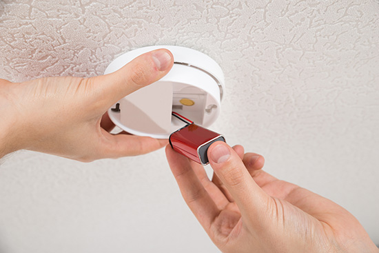checking smoke alarm batteries