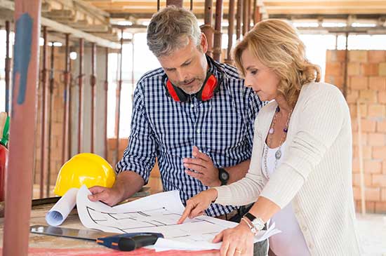 female builder going over construction plans