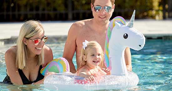 family playing in a pool