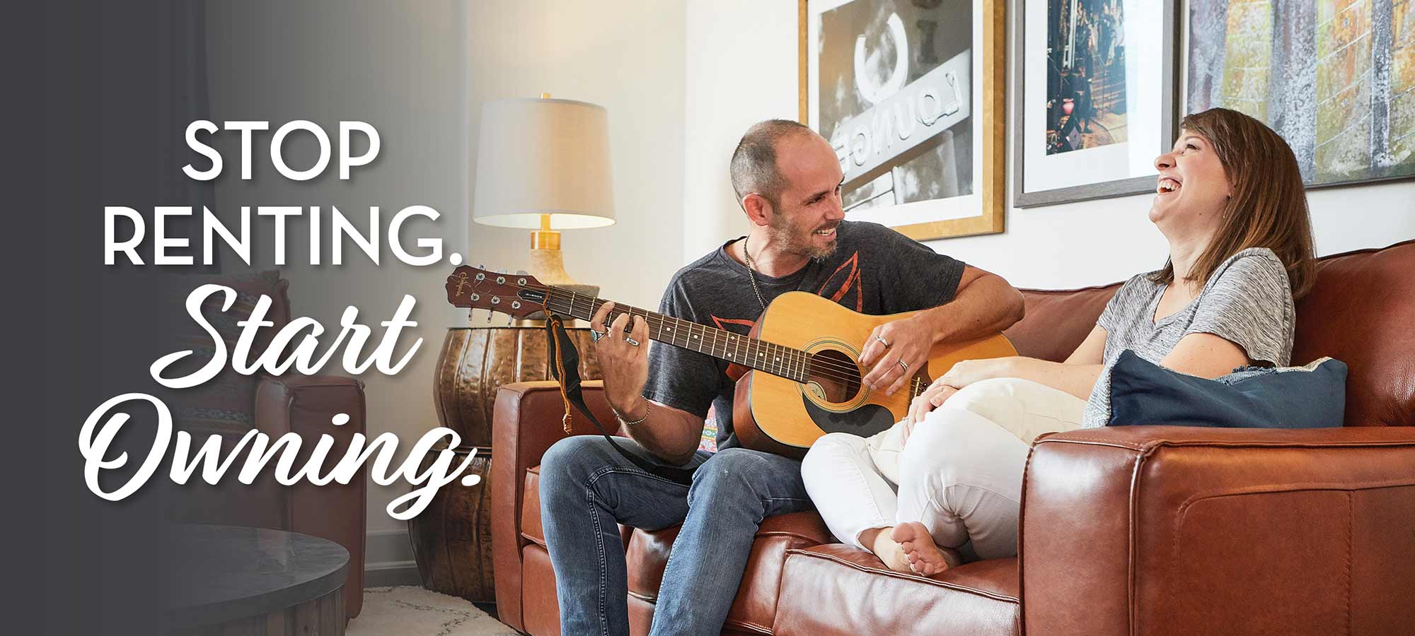 man and woman sitting on couch, man playing guitar