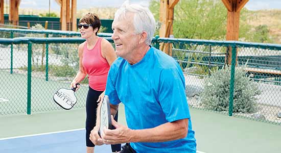 man and woman playing pickleball